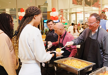 President serving student food
