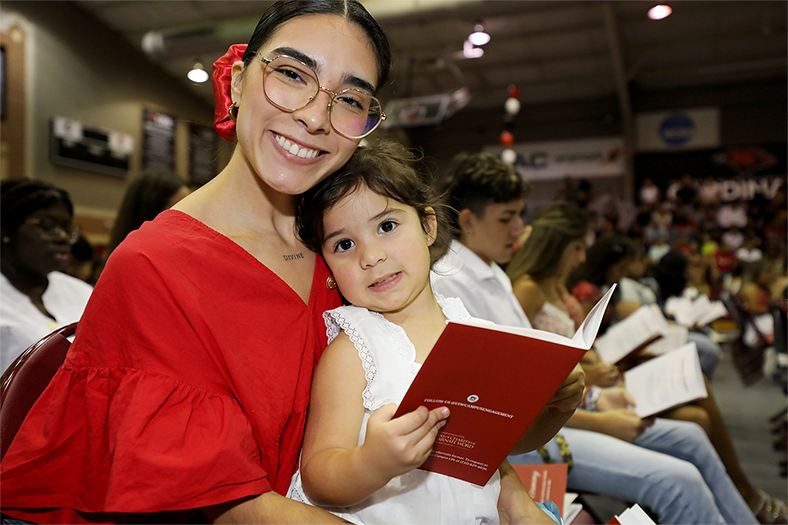 2024 female with child sitting pinning ceremony