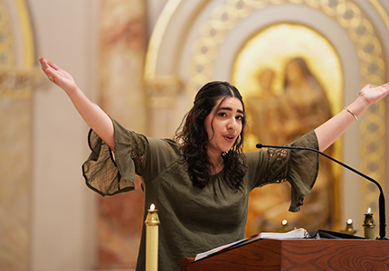 Woman singing at church podium